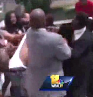 Adults brawl behind the Towson University SECU Center following a high school graduation. www.blacklikemoi.com